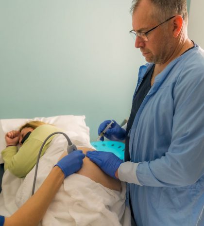 Dr Michael Jamieson injects PRP into a patient's hip whilst Christine Adams scans the area with Ultrasound